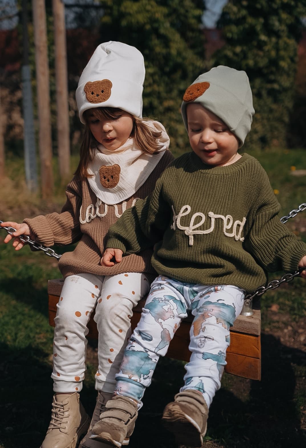Zwei Kinder mit personalisierten Strickpullovern von bubi and you